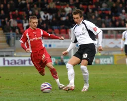 Darren Currie passes the ball on