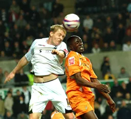 Paul Furlong jumping for the ball