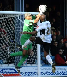 Paul Furlong challenges the keeper
