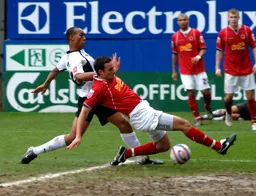Calvin Andrew putting the Crewe defender under pressure