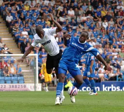 Claude Gnakpa tries to get round a Gills defender