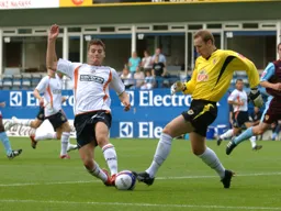 Notts keeper Kevin Pilkington nicks the ball off the toe of Chris Martin