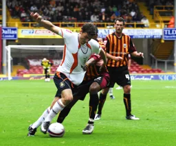 Chris Martin battles through watched by former Hatter Paul McLaren