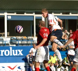 Asa Hall heads the ball down