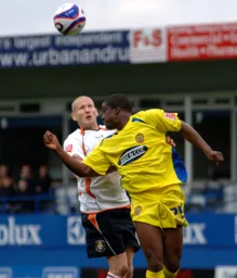 Kevin Nicholls heads the ball away