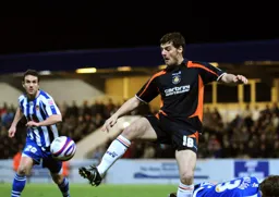 Chris Martin concentrates on bringing the ball under control