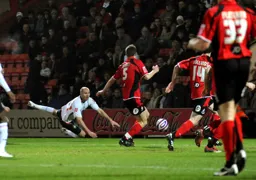 Sam Parkin dives to head the ball across the area