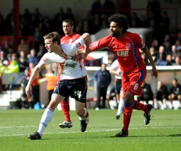 Tom Craddock has his shirt pulled by Anthony Charles