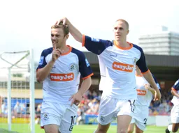 Tom Craddock has just scored Town`s goal from the penalty spot. Asa Hall joins in the celebration