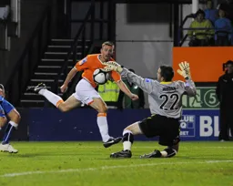Tom Craddock sees his shot saved by Nick Jordan