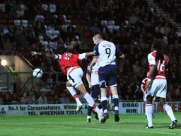 Liam Hatch heads the ball goalwards