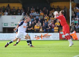 Dan Potter makes a safe catch from the onrushing Liam Hatch