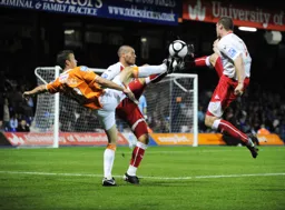 High boots everywhere as Tom Craddock fights for the ball