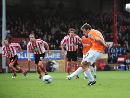 Tom Craddock puts away the penalty for the only goal of the game