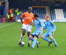 Claude Gnakpa is closed down by two defenders