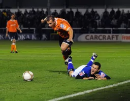 Jake Howells leaves a Rochdale defender sprawling on the turf