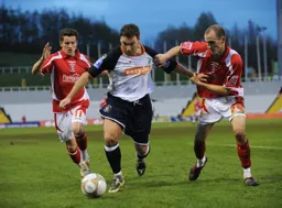 Kevin Gallen and Andy Nicholas wrestle for the ball
