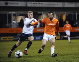Fred Murray is held as he challenges for the ball