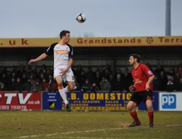 Tom Craddock gets in a header