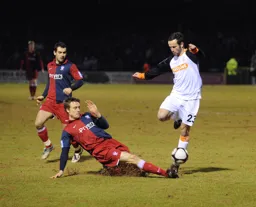 Fred Murray rides a tackle with future Hatter Alex Lawless looking on