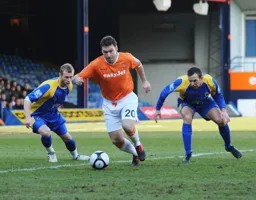 Kevin Gallen gets away from two defenders