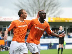 3-0 Claude Gnakpa celebrates with Jake Howells after scoring his second and Town`s third goal