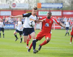 Tom Craddock tussles for the ball with Michael Blackwood