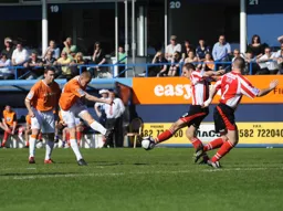 Simon Heslop hammers in a shot from outside the penalty area