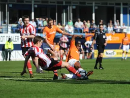 Adam Newon slides in for a tackle