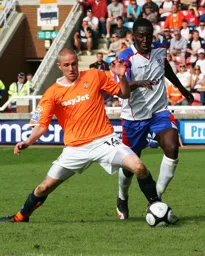 Asa Hall in a tussle for the ball with future Hatter Curtis Osano