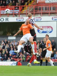 Adam Murray loses out in this midfield battle