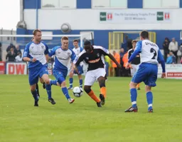 Godfrey Poku shows his midfield strength. Barrow player Jason Walker in the background will play a key role in Luton's season