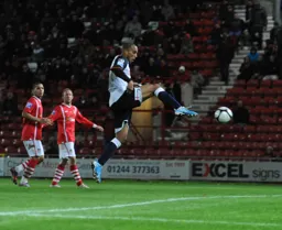 Tall striker Taiwo Atieno has to leap to get a foot to this ball