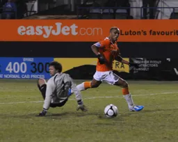 Taiwo Atieno beats the goalkeeper but the ball sails wide