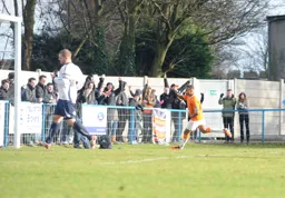Matthew Barnes-Homer celebrates with the Town fans in the away end