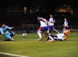 Jason Walker dives full length but the Rushden and Diamonds keeper is ready