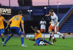 Adam Watkins hurdles over a sliding tackle