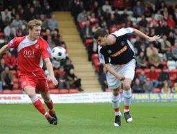 Jamie Hand heads the ball forward