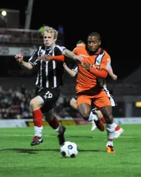 Aaron O`Connor bustles his way past Bradley Wood