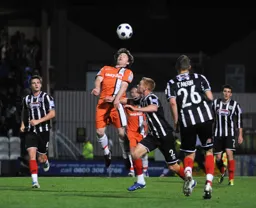 John-Paul Kissock wins a header in midfield