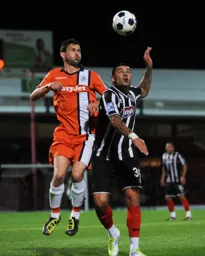 Jamie Hand gets above Anthony Elding to win a header