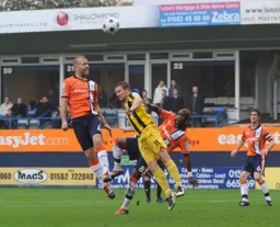 Keith Keane gets above Jamie McGuire to win an attacking header