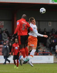 Janos Kovacs and Francino Francis challenge for a high ball