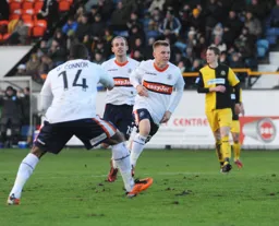 Adam Watkins is off to celebrate after scoring Town`s second goal.