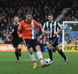 Greg Taylor looks to play the ball down the left