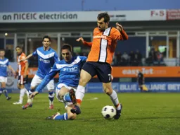 Alex Lawless goes in for a tackle with John Challinor