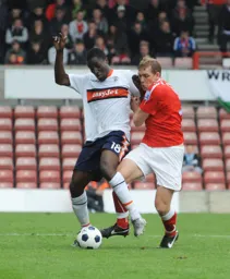 Curtis Osano rides a tackle