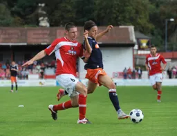 Jake Woolley holds off an Ebbsfleet defender