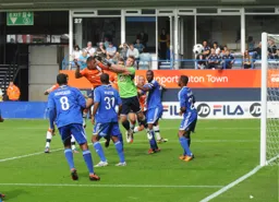 Andre Gray beats Lance Cronin to the ball to head in Town`s second goal