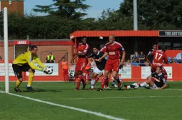 Yaser Kasim closes in as Jon Stewart gathers the ball